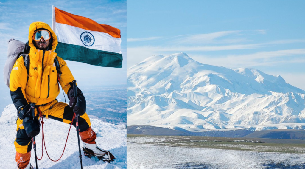 Rohtash Khileri standing on the summit of Mount Elbrus, clouds below, snow around him